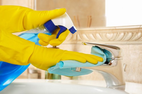 Cleaner treating a carpet stain in a local Fulham flat